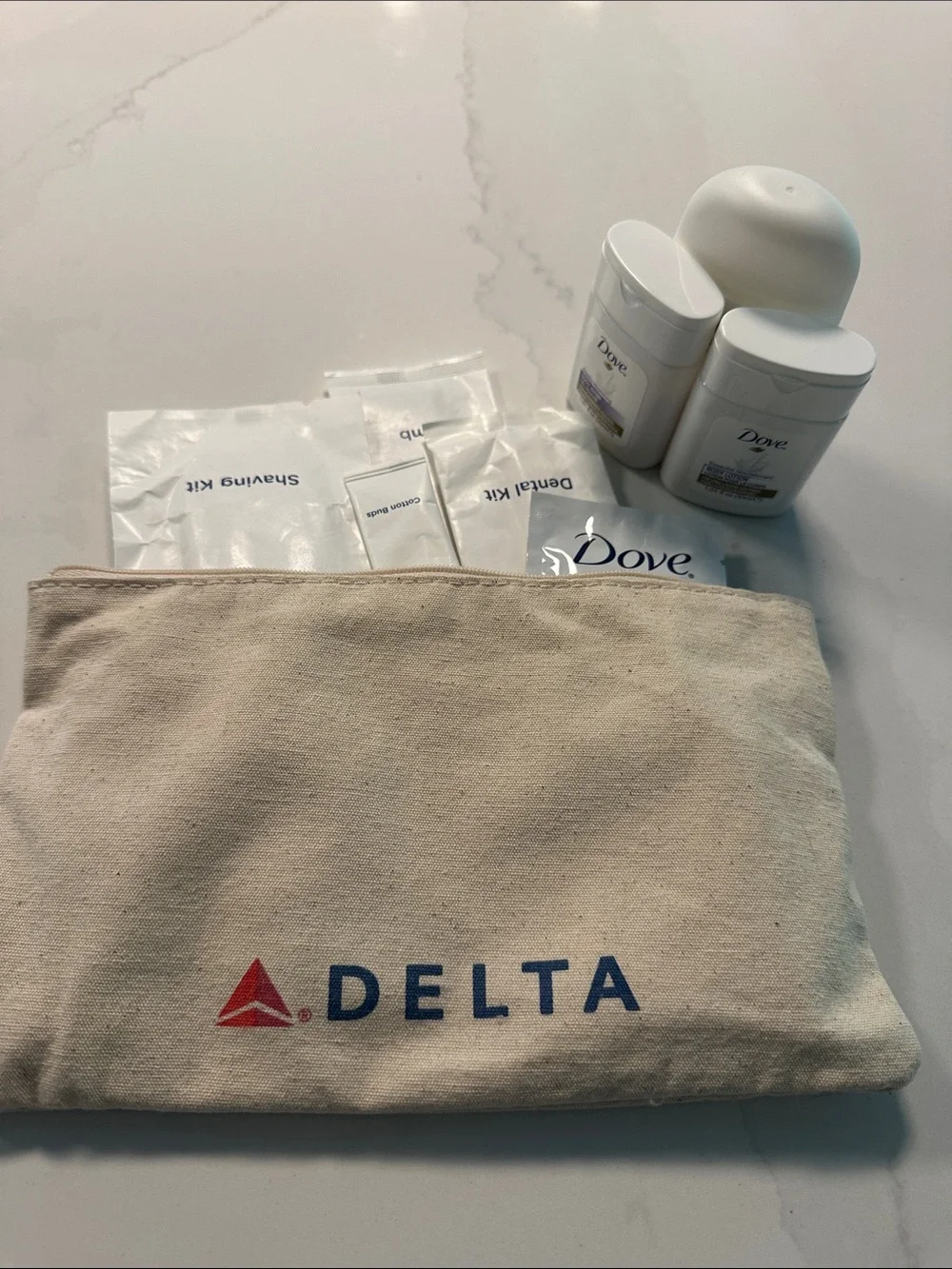 NWOT- Delta Travel Amenity Pouch with Toiletries in Beige and Red/Blue Logo